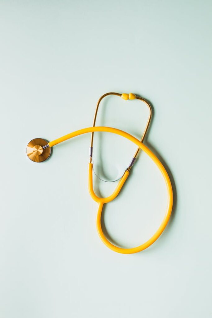 pexels-photo-4386464 Top view of yellow medical stethoscope placed on white surface during coronavirus pandemic